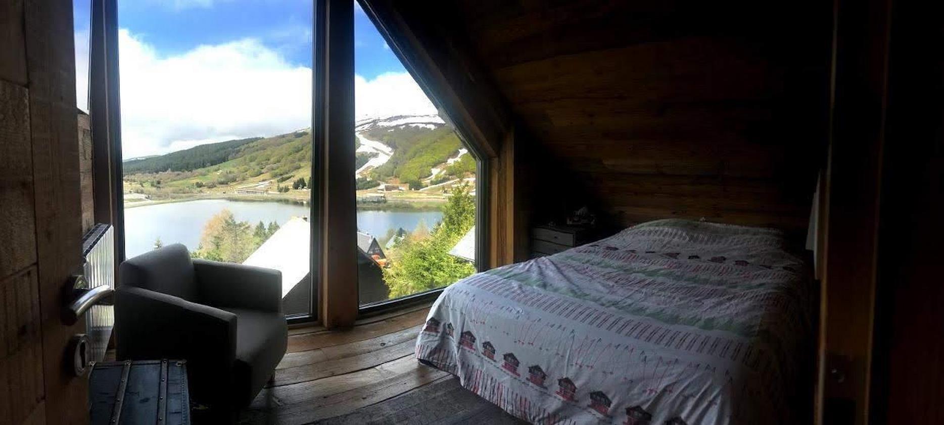 Gite Super Besse - bedroom with king size bed, flat screen, wifi, sound bar and magnificent view