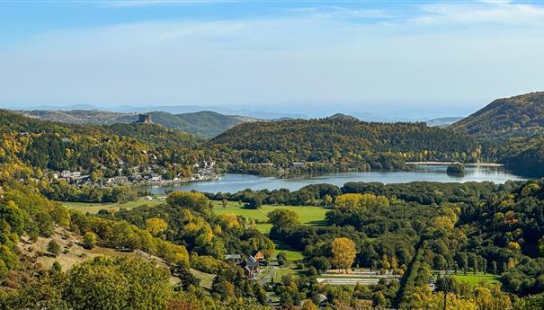Auvergne, Le Lac Chambon in its autumn colours. Nice view of the castle of Murol. Discover Lac Chambon, high altitude lake in the Puy de Dome