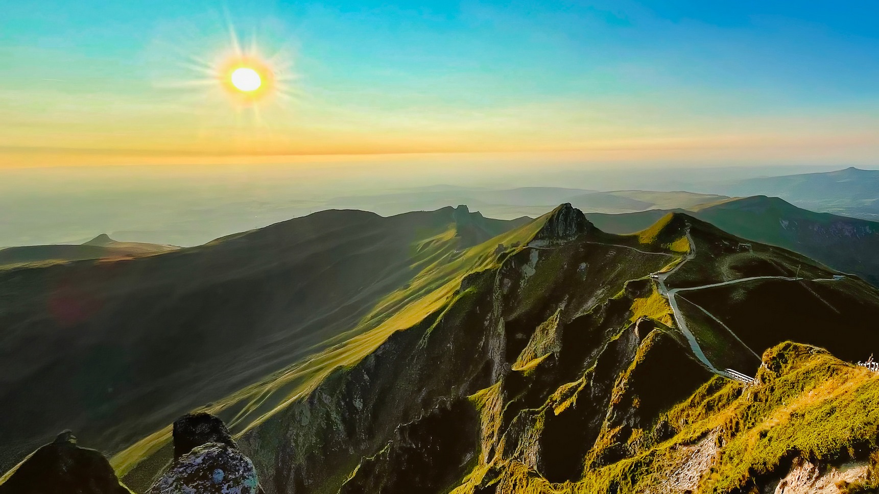 At the top of the Puy de Sancy, sunset over the peaks of the Massif du Sancy