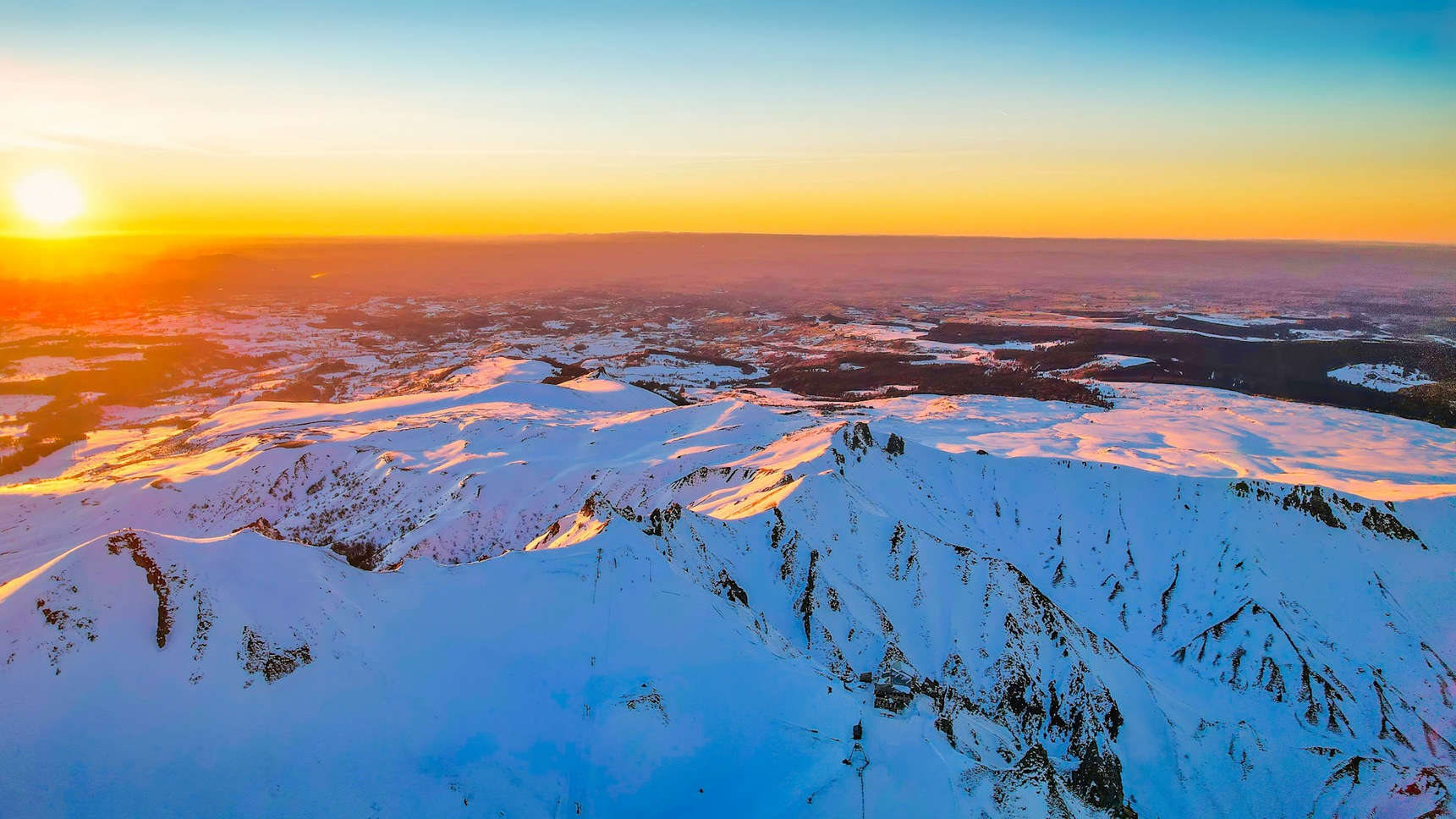 Sunset at Puy de Sancy, over the Val d'Enfer and the arrival station of the Sancy cable car