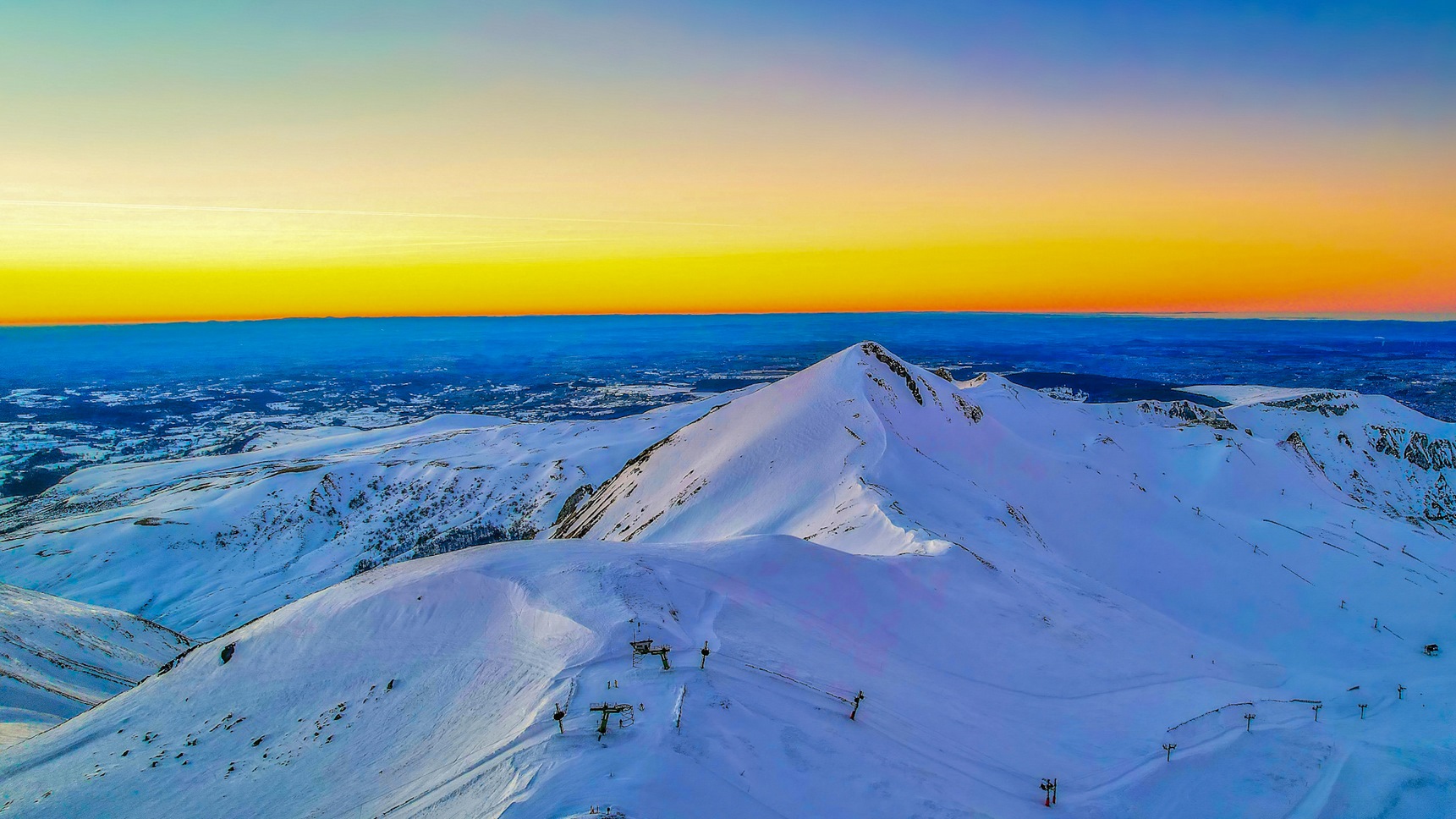 At the top of Puy Ferrand, magnificent view of Puy de Sancy at sunset