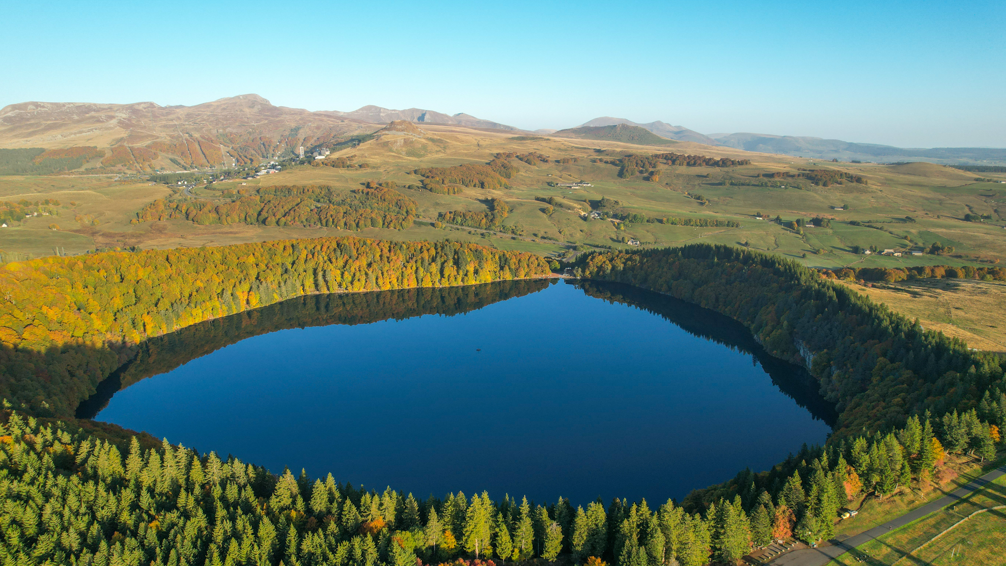 Lac Pavin, panorama of the Massif du Sancy and Super Besse