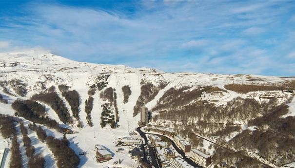 Super Besse seen from the sky, the Perdrix cable car and the town center of Super Besse