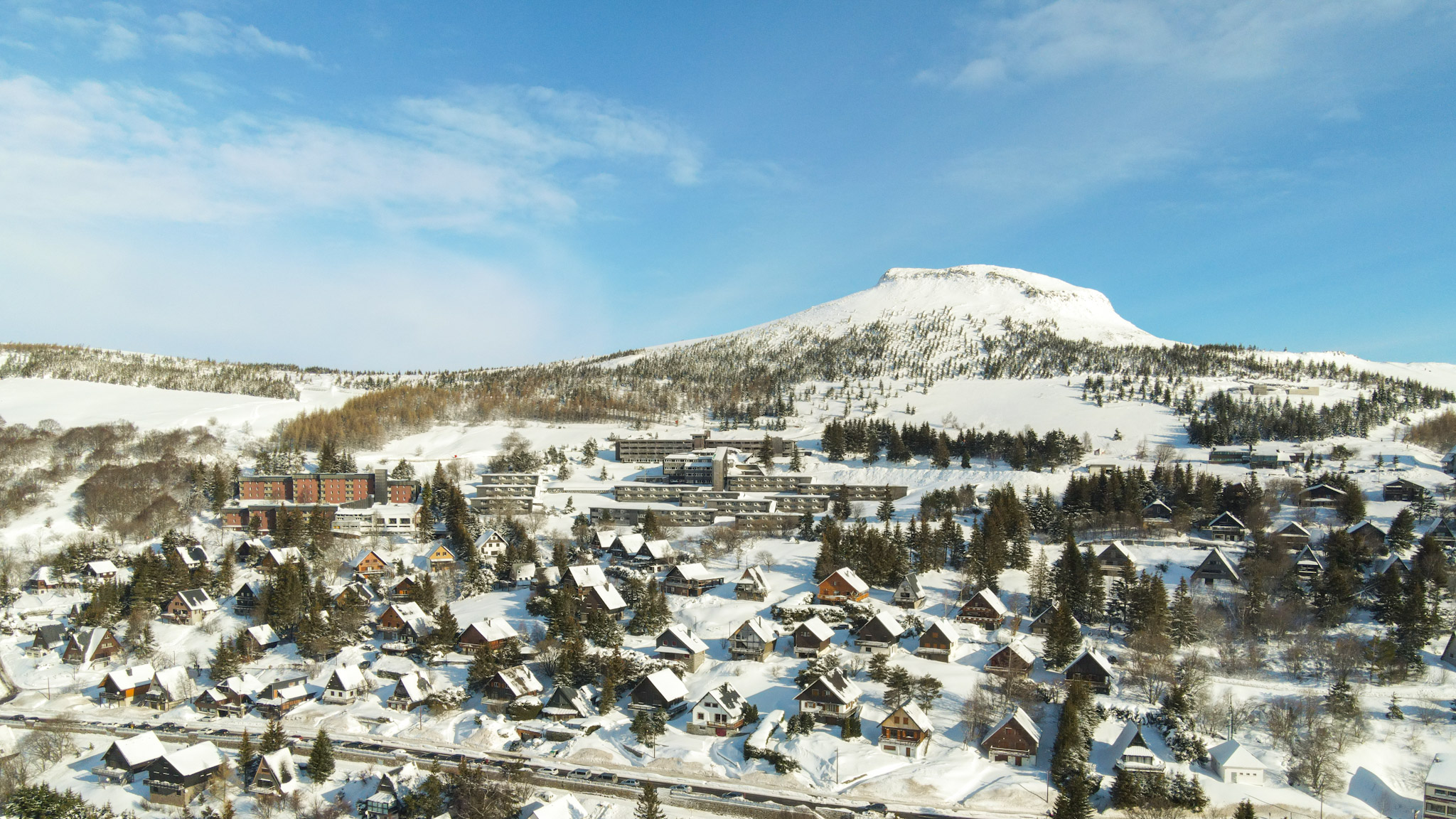 Super Besse seen from the sky, the village of chalets on the slopes of Puy du Chambourguet