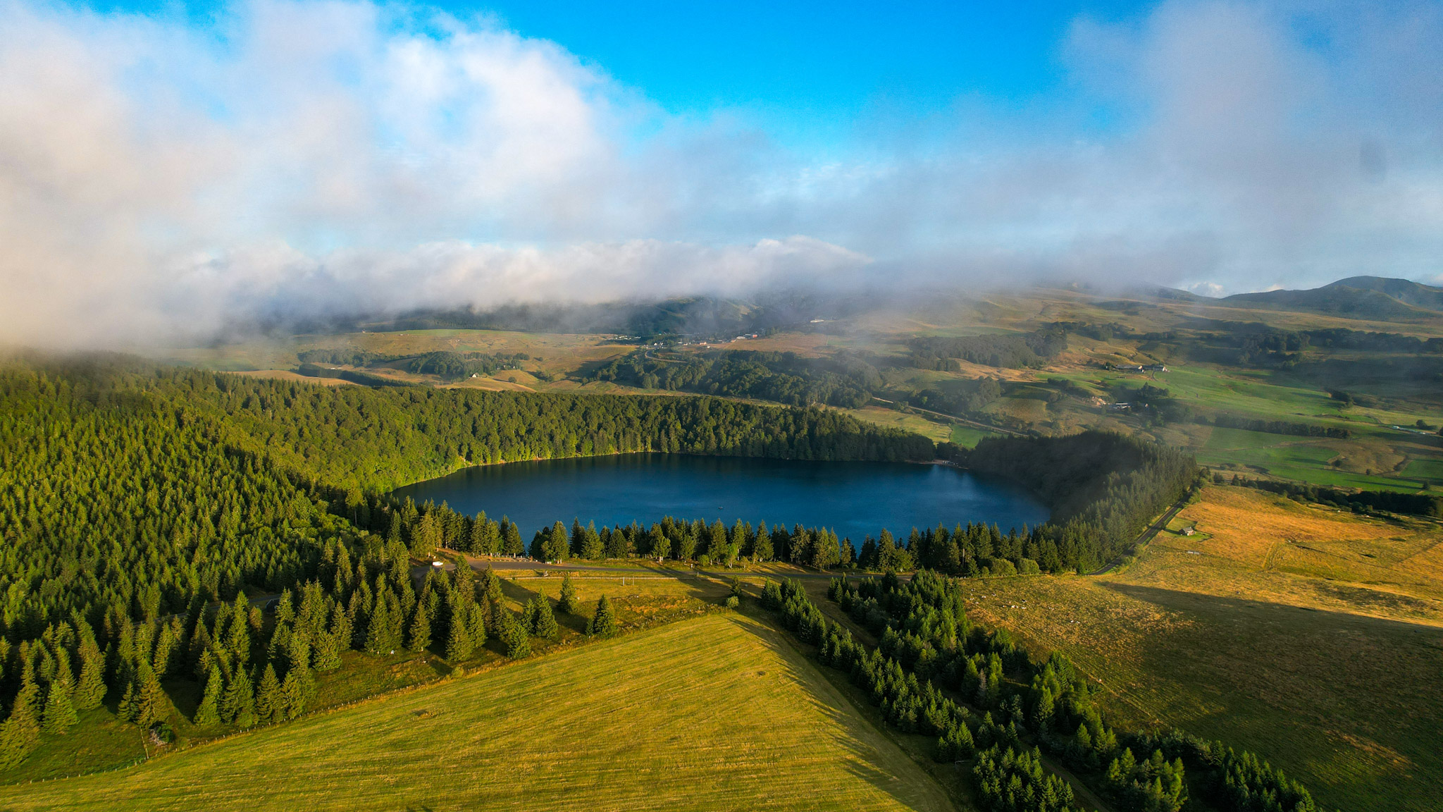 Lac Pavin and the Massif du Sancy under the clouds